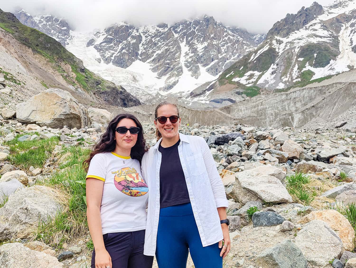 Travellers stood in front of the Shkhara glacier, Ushguli, Georgia
