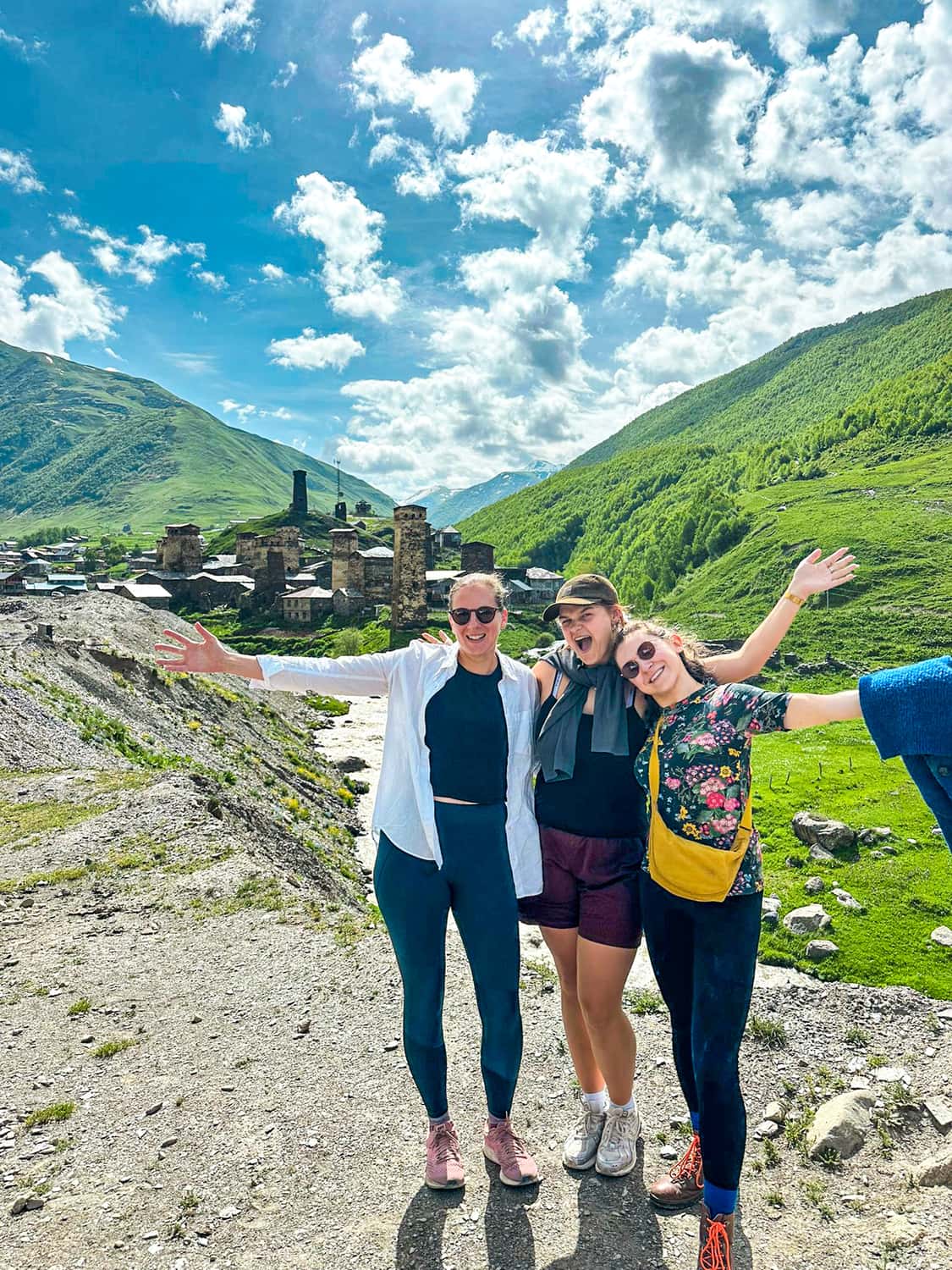 Travellers stood in front of Mestia town, Georgia