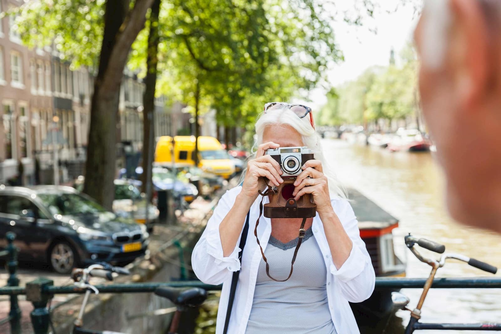 Woman and man with camera taking picture in Amsterdam, Netherlands