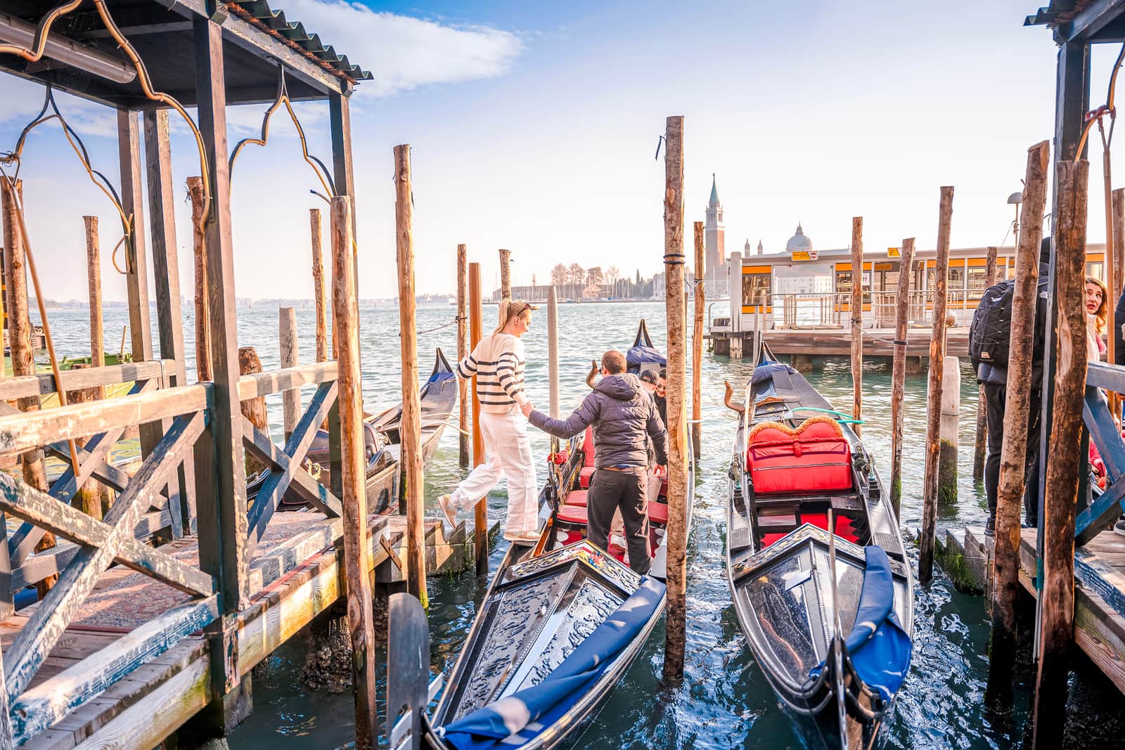 A traveller being helped onto a gondola in Venice, Italy
