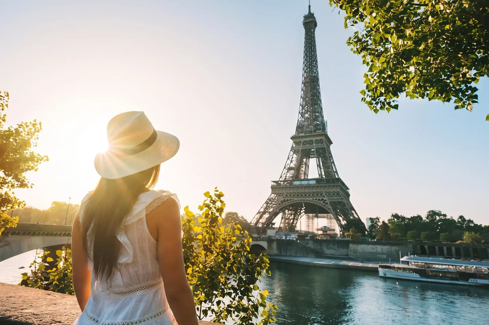 A woman overlooking the Eiffel Tower and the Seine River in Paris, France.