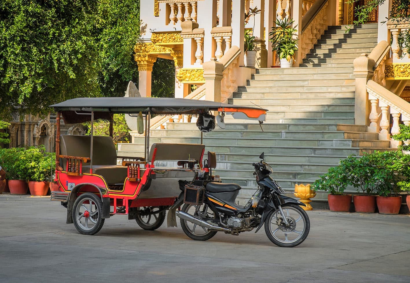 Red Tuk Tuk Parked Outside a Ornate Building, Cambodia