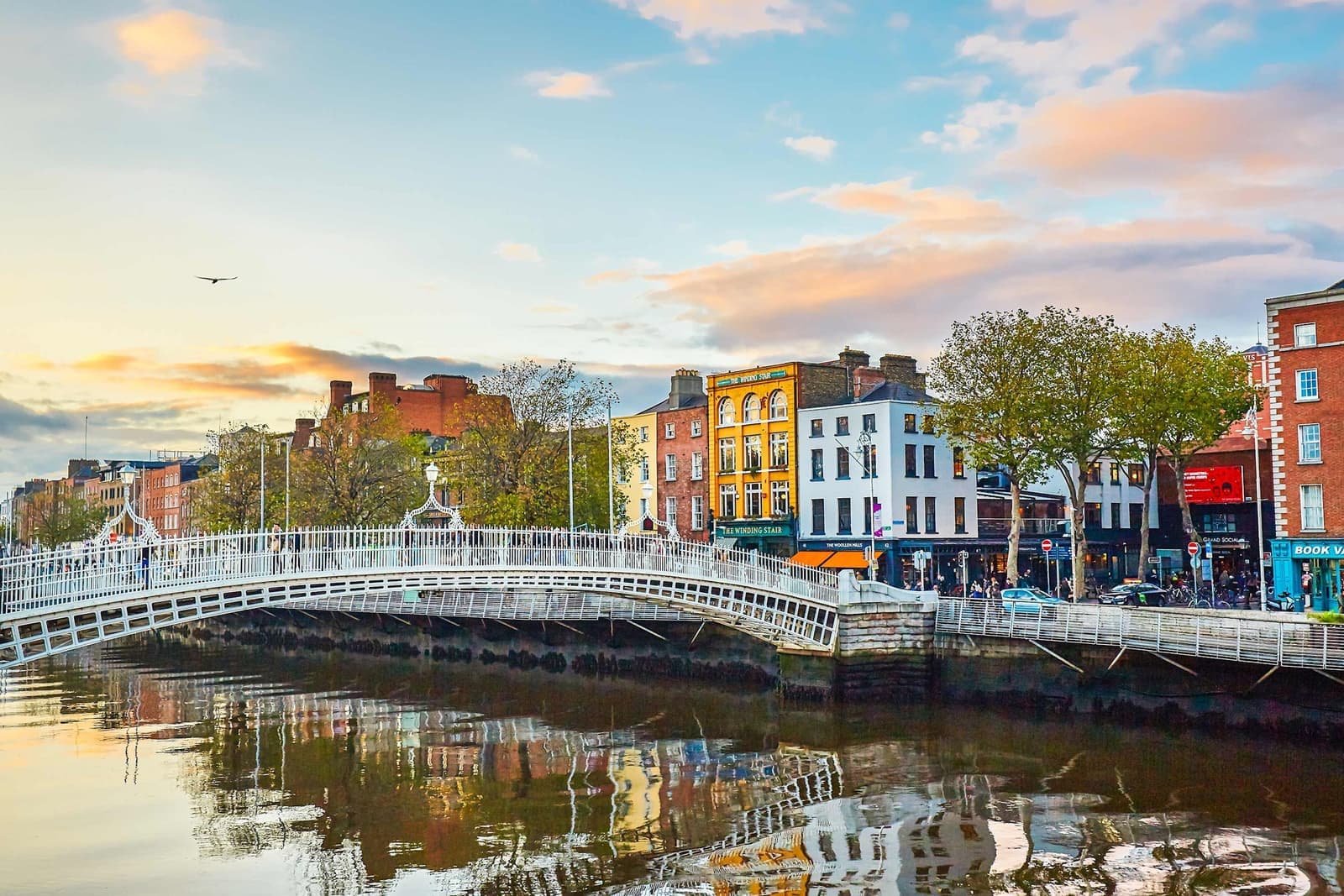 Ha'penny Bridge over River Liffey with reflections in Dublin, Ireland