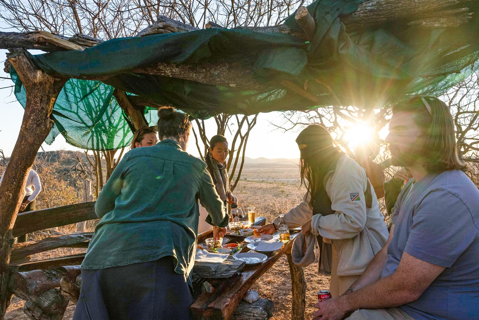 Travellers helping themselves to food, Etosha National Park, Namibia