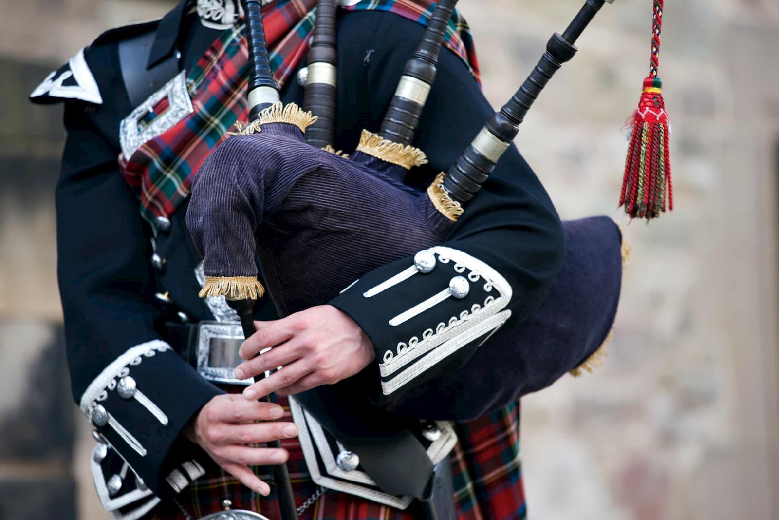 A person holding a set of bagpipes in Glasgow, Scotland