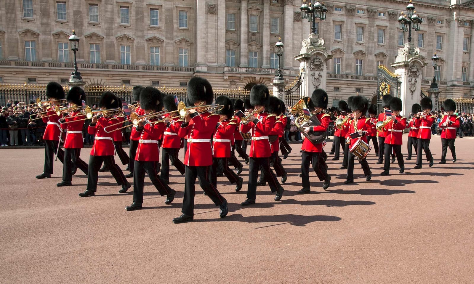 A group of guards marching in front of Buckingham Palace in London, England
