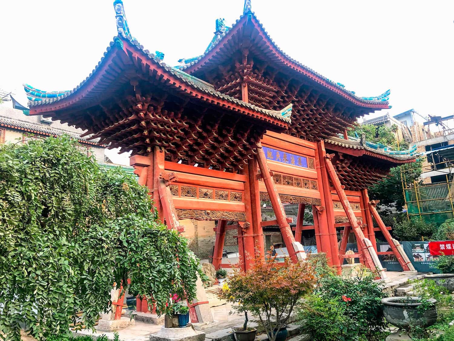 Red wooden gate with three arches at Great Mosque of Xi’an, China