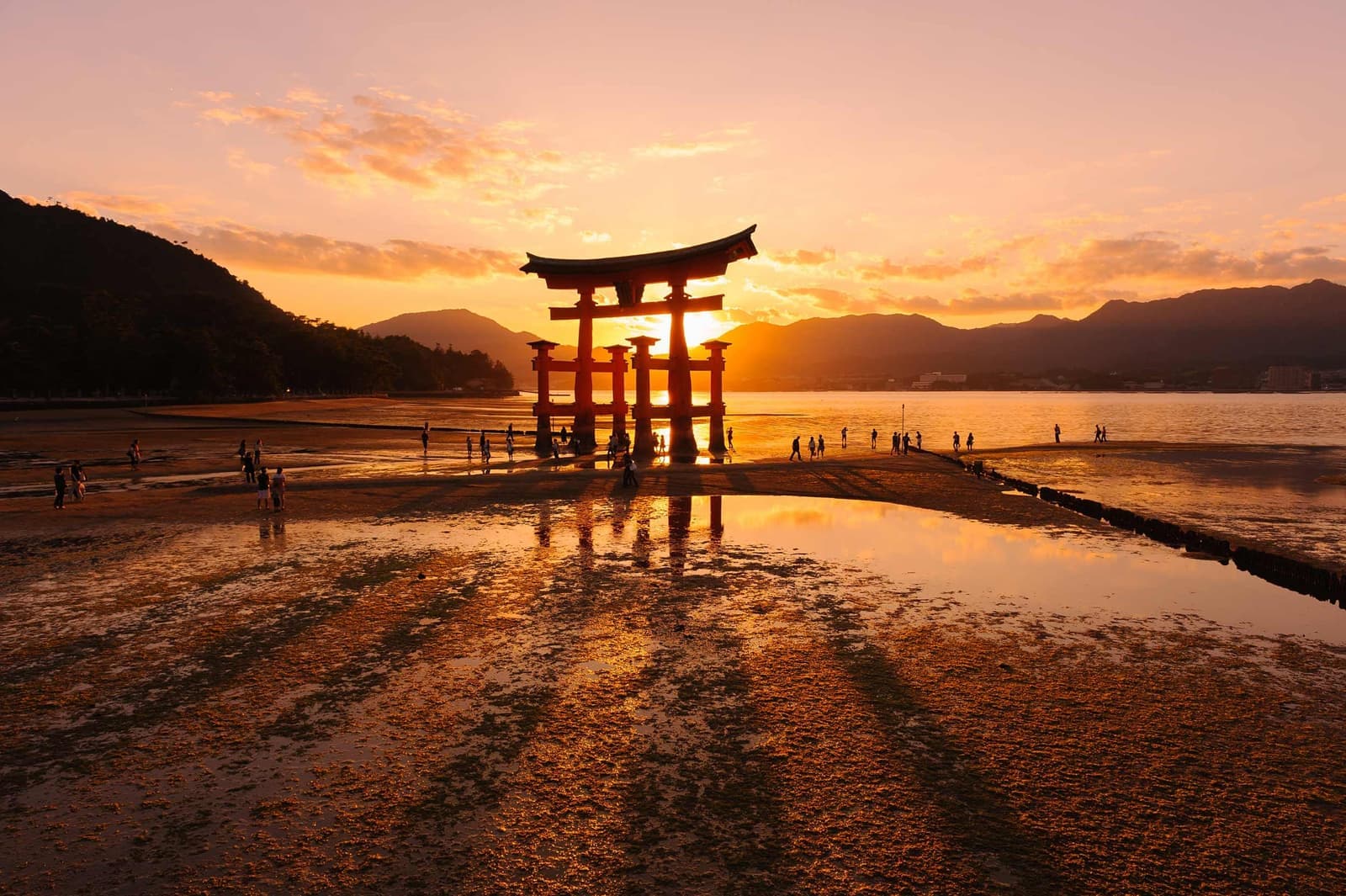 The sun setting on Itsukushima Shrine in Miyajima Island, Japan