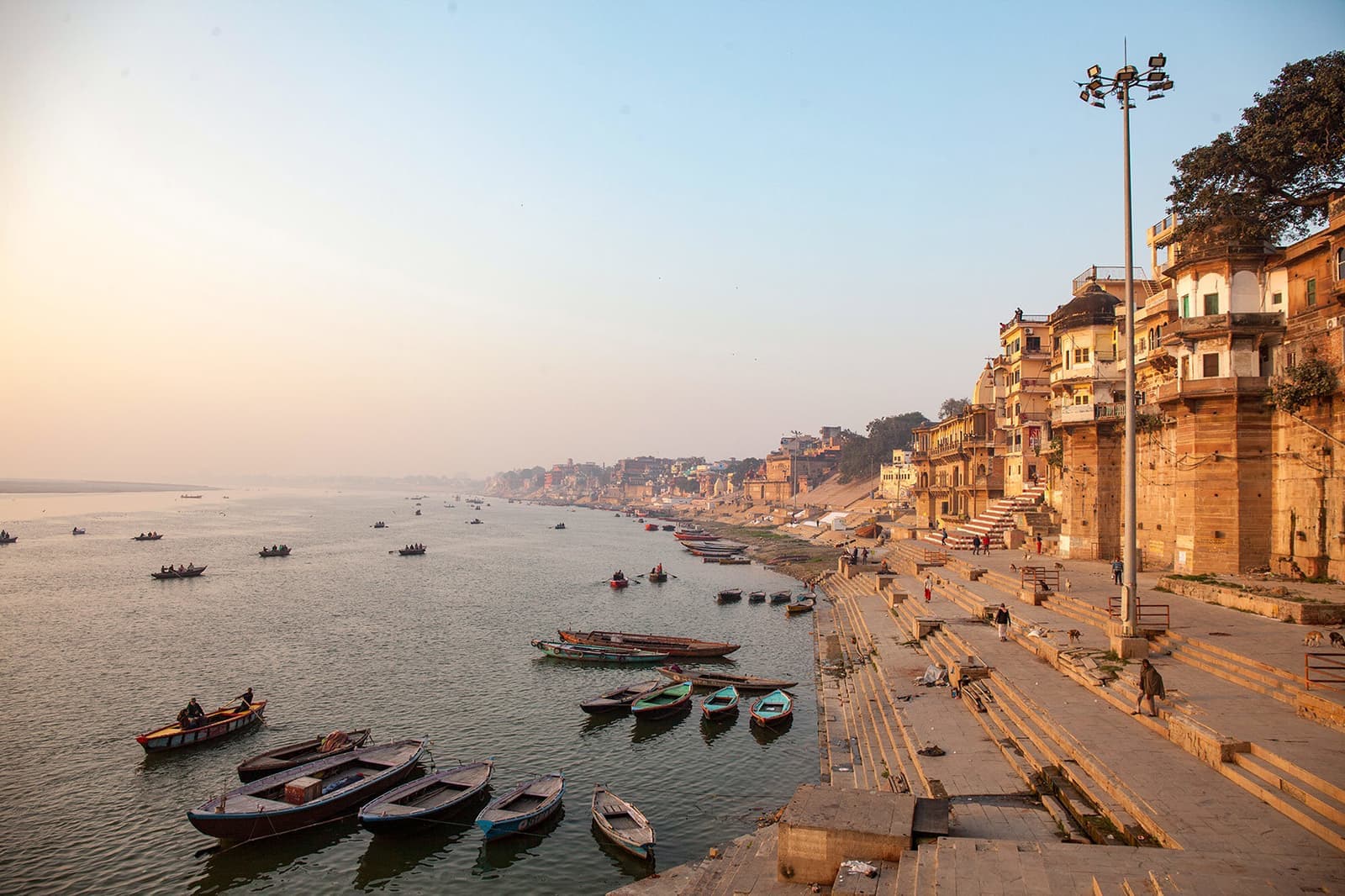 A panoramic view of ancient Indian riverfront steps with boats, Varanasi, India