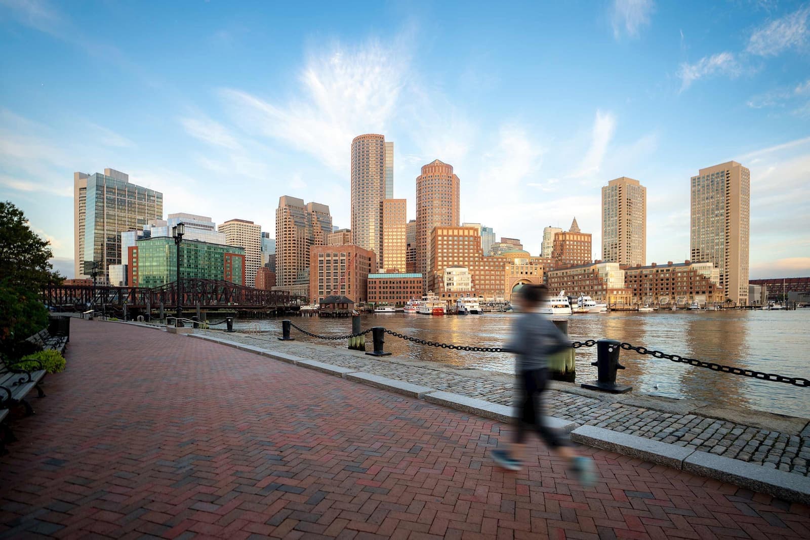 A jogger running through Seaport in Boston, Massachusetts, USA