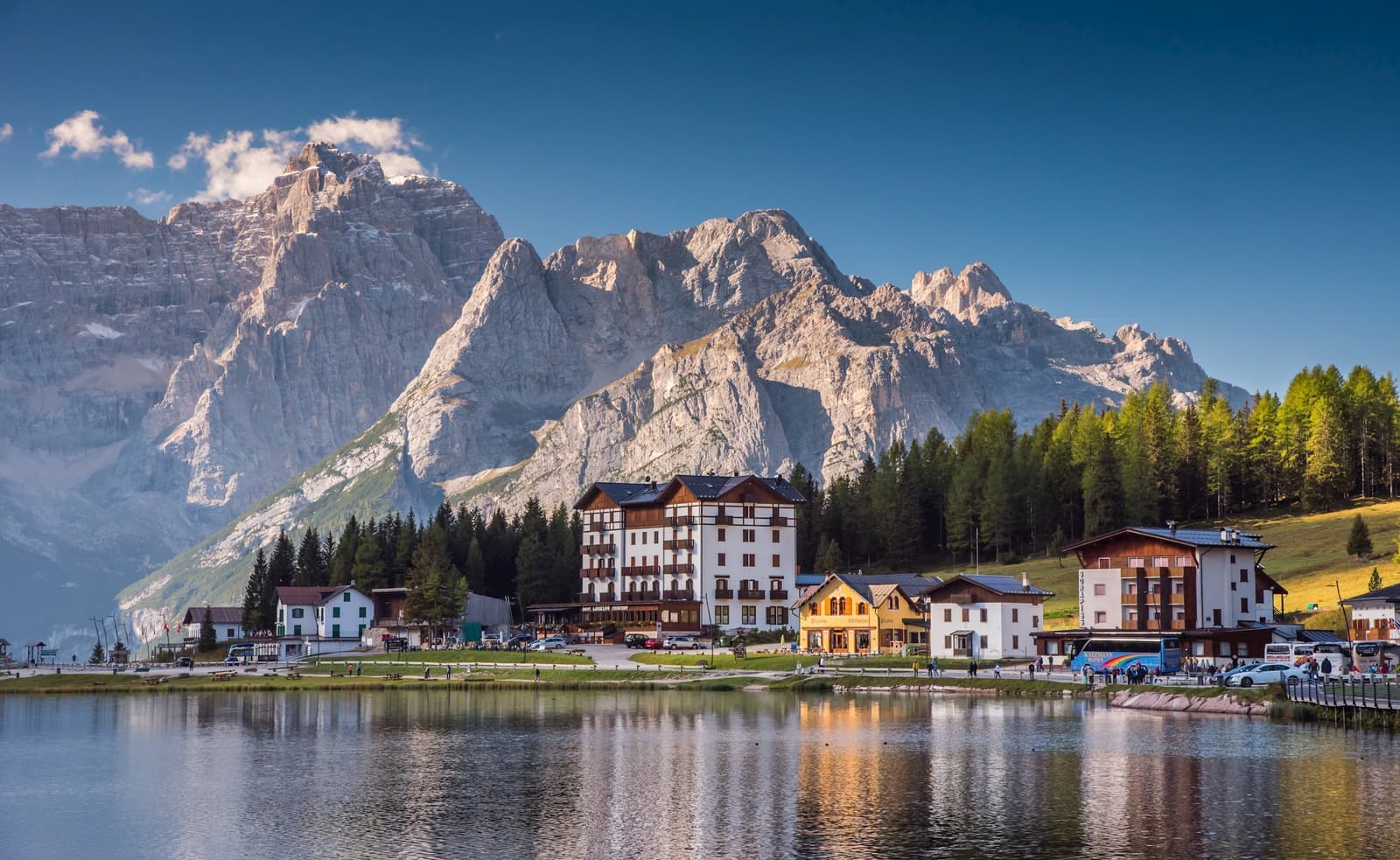 View of houses reflecting in Misurina Lake, Dolomites, Italy