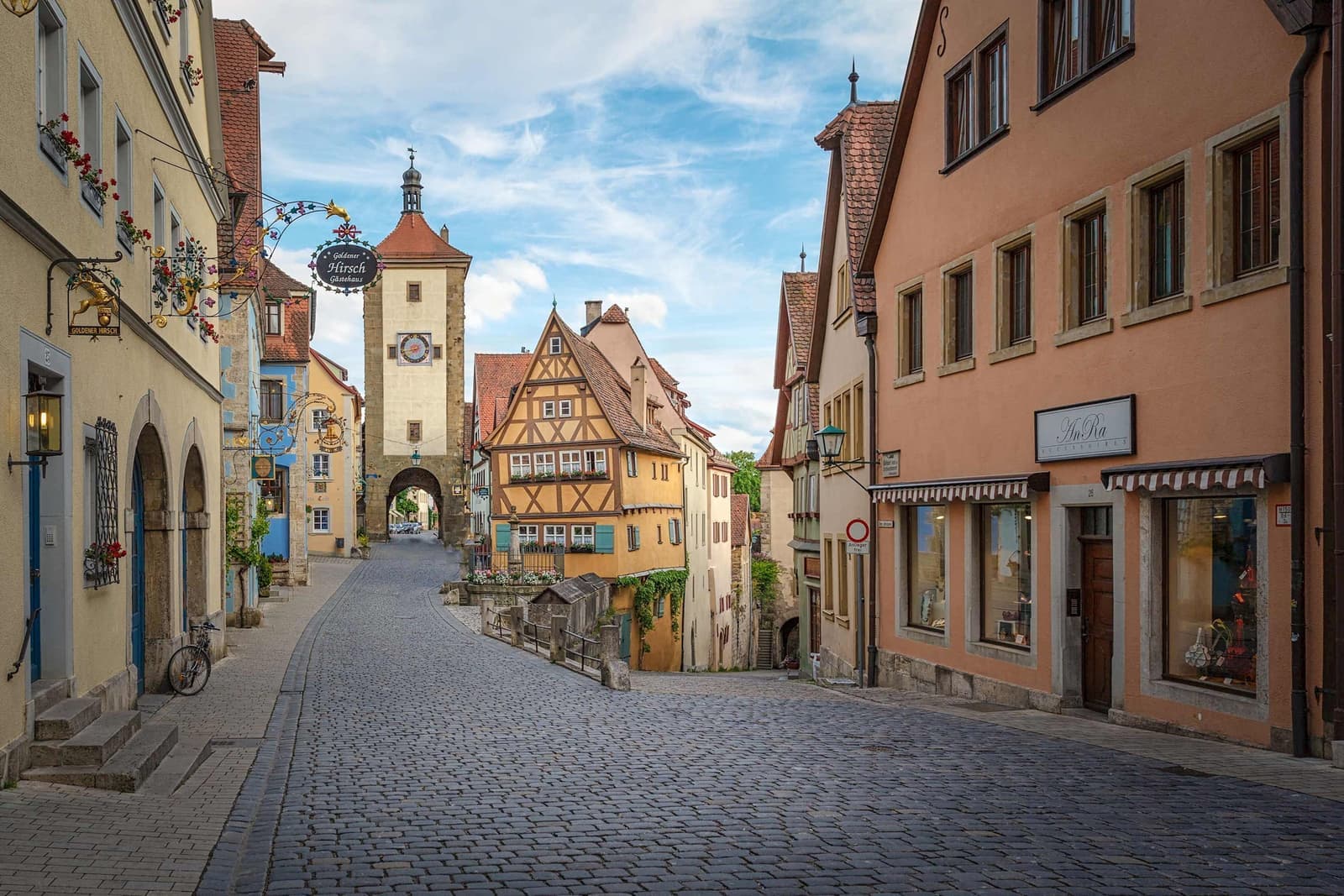 Cobblestone street lined with colourful houses in Rothenburg, Germany