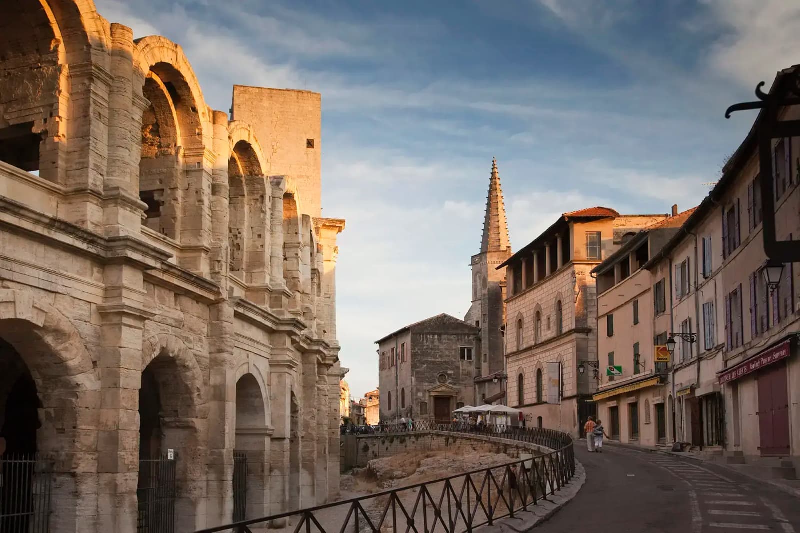 The ancient Arles Amphitheatre and a cobblestone street in southern France.