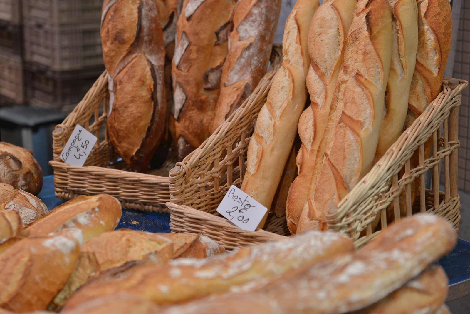 Baked baguettes stacked in woven baskets in Paris, France