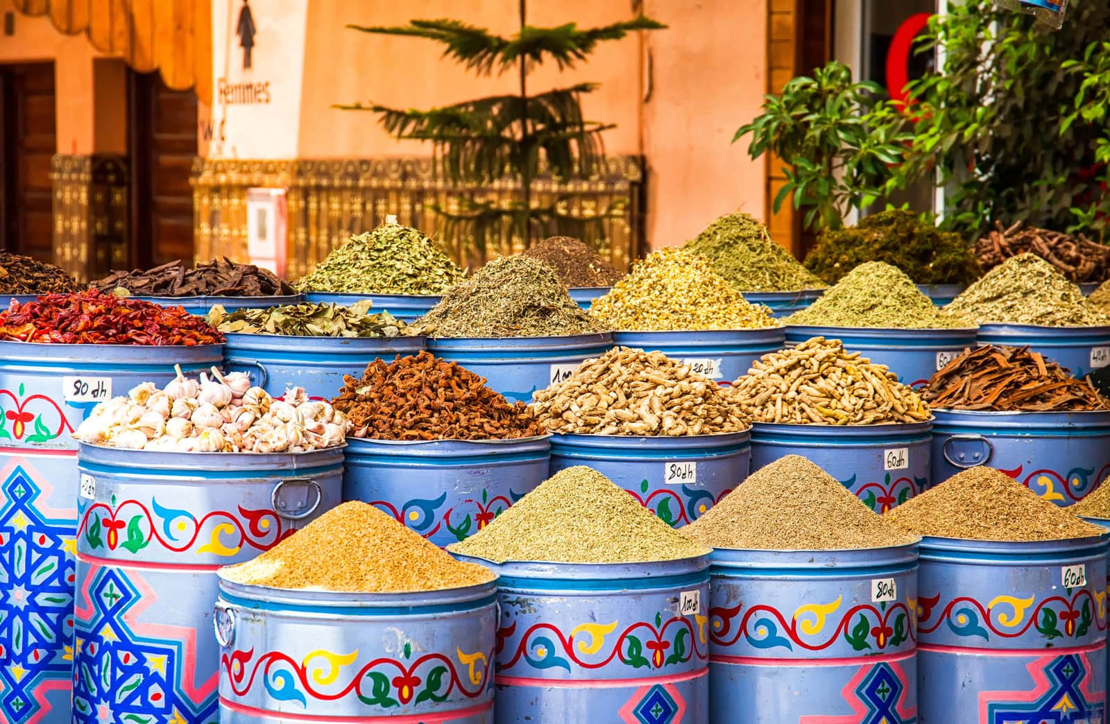 Colourful metal containers filled with assorted spices