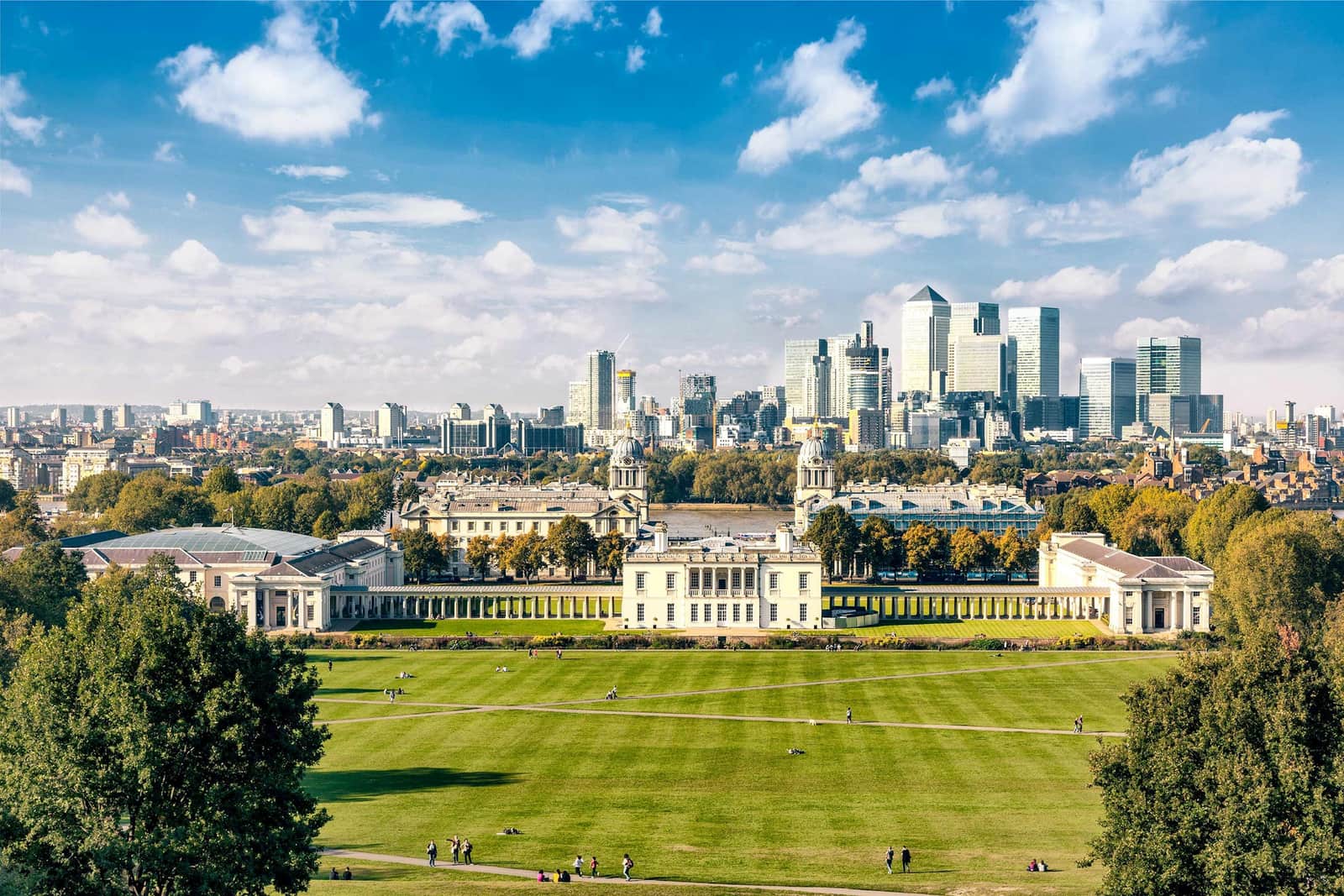 Greenwich Park lawn with college buildings and London skyline in background