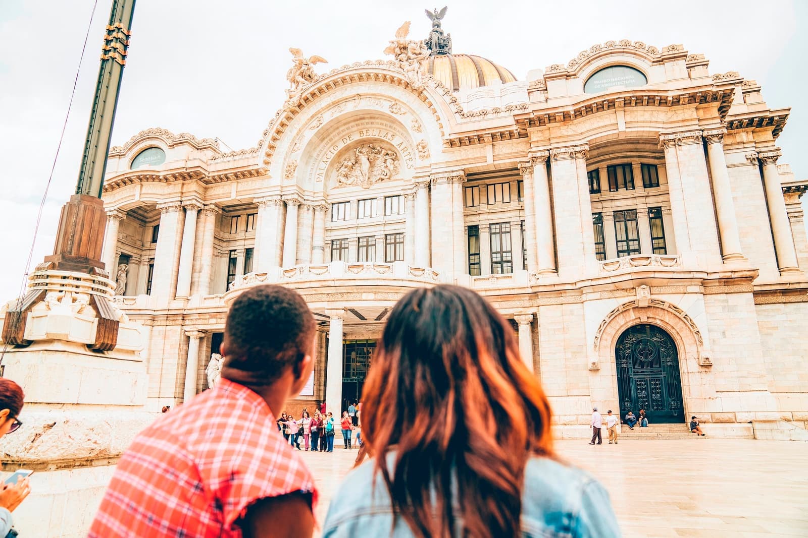 Travellers in front of the Palace of Fine Arts in Mexico City, Mexico