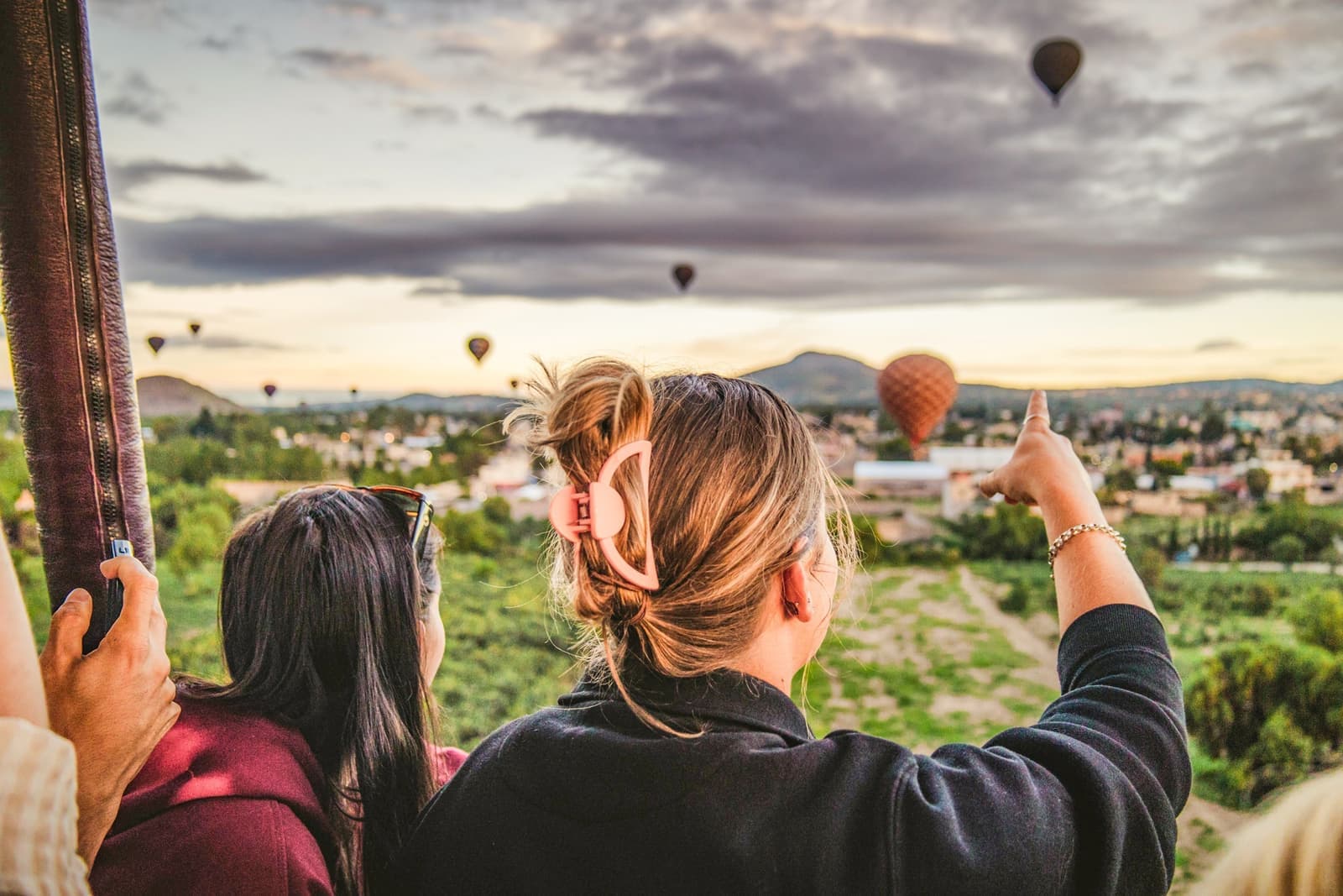 Photo Taken from Behind Traveller Pointing Towards the Sky During Hot Air Balloon Ride, Teotihuacan, Mexico