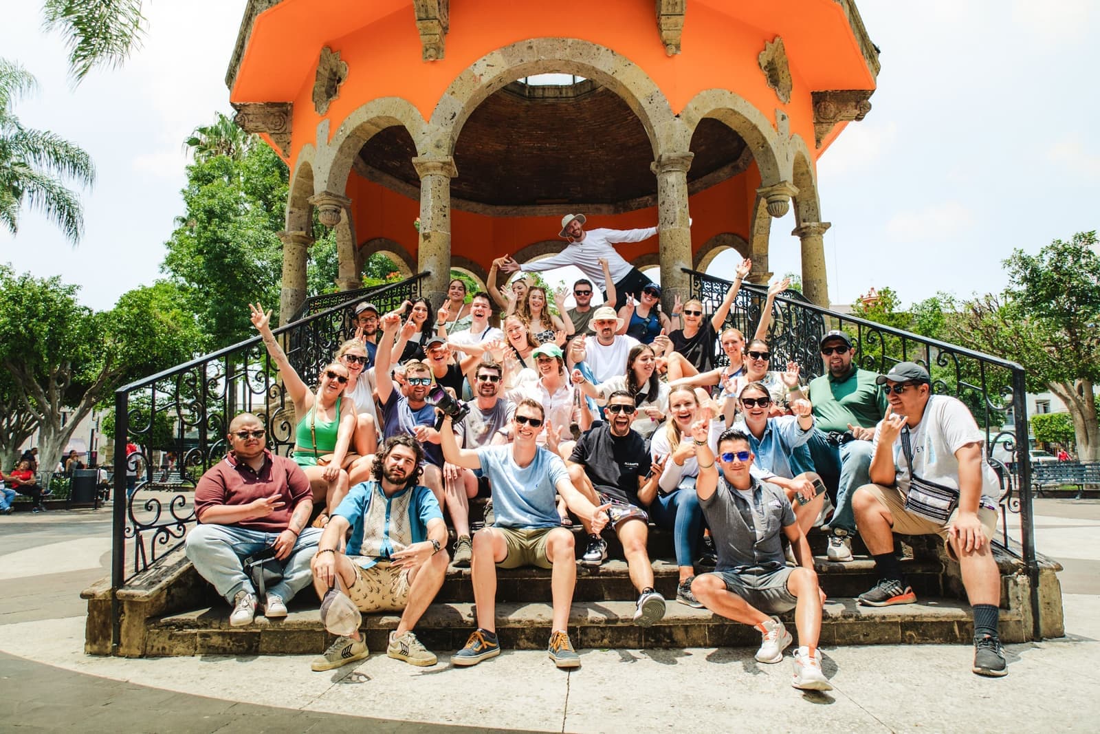 Large Group of Travellers Sat Across Steps to Orange Bandstand, Mexico City, Mexico