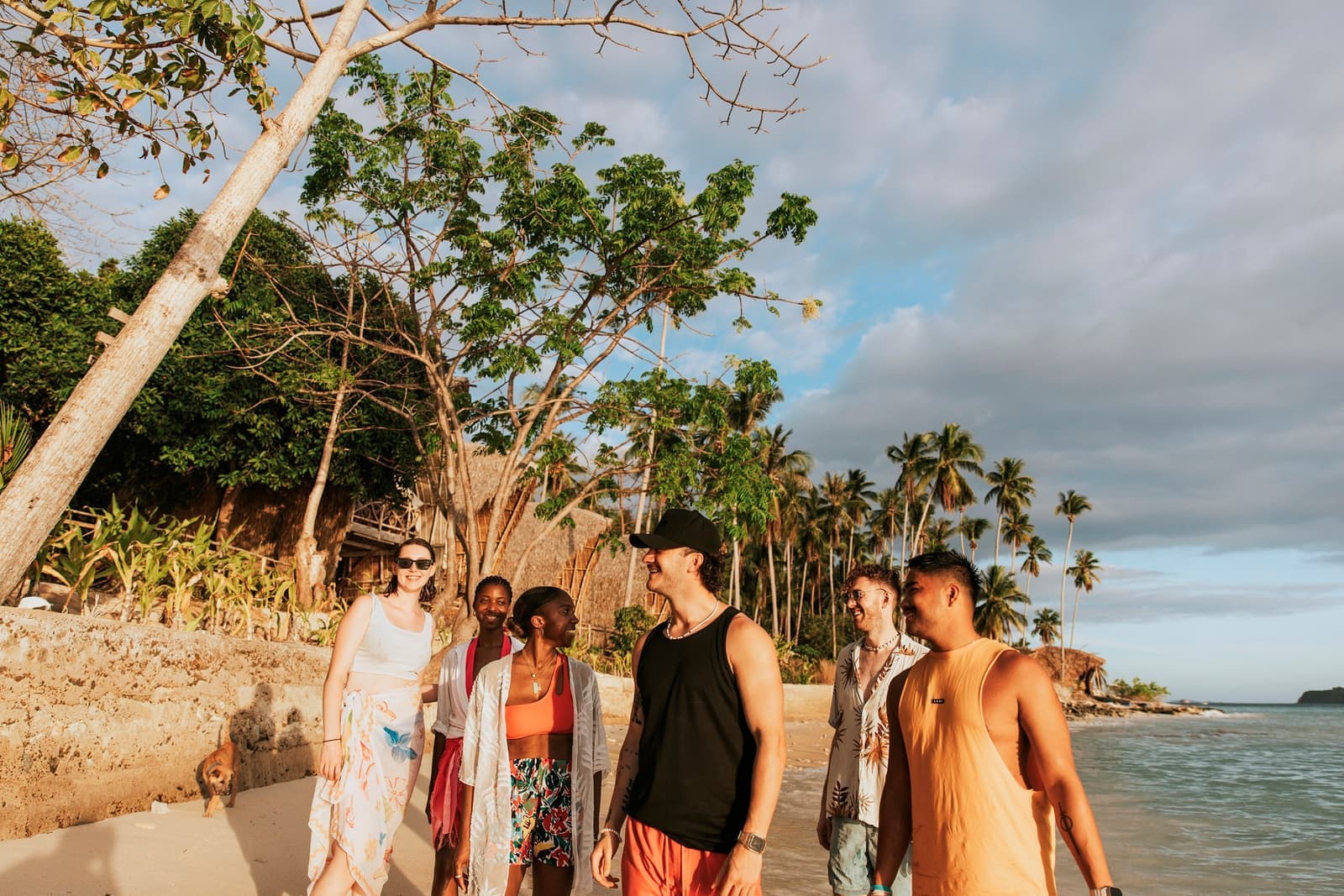 Travellers Walking Along Beach in Sunlight Beside Darocotan Special Stay, Philippines