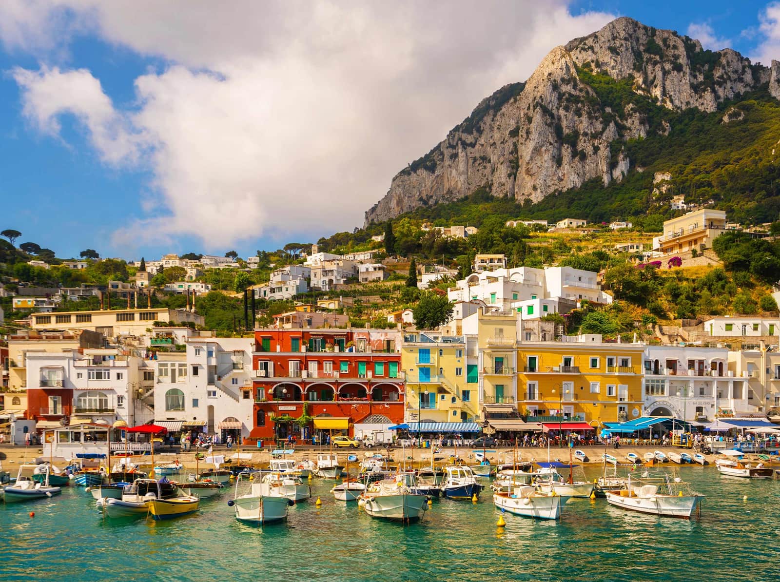 Colourful waterfront buildings and boats in Marina Grande harbour on Capri Island.
