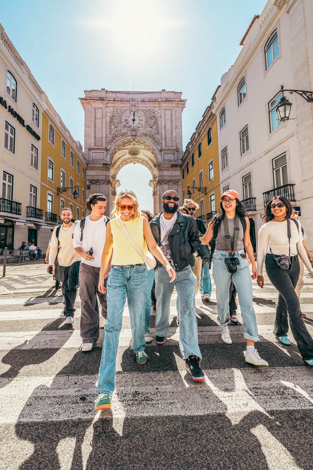 Travellers walking away from Praça do Comércio, Lisbon, Portugal