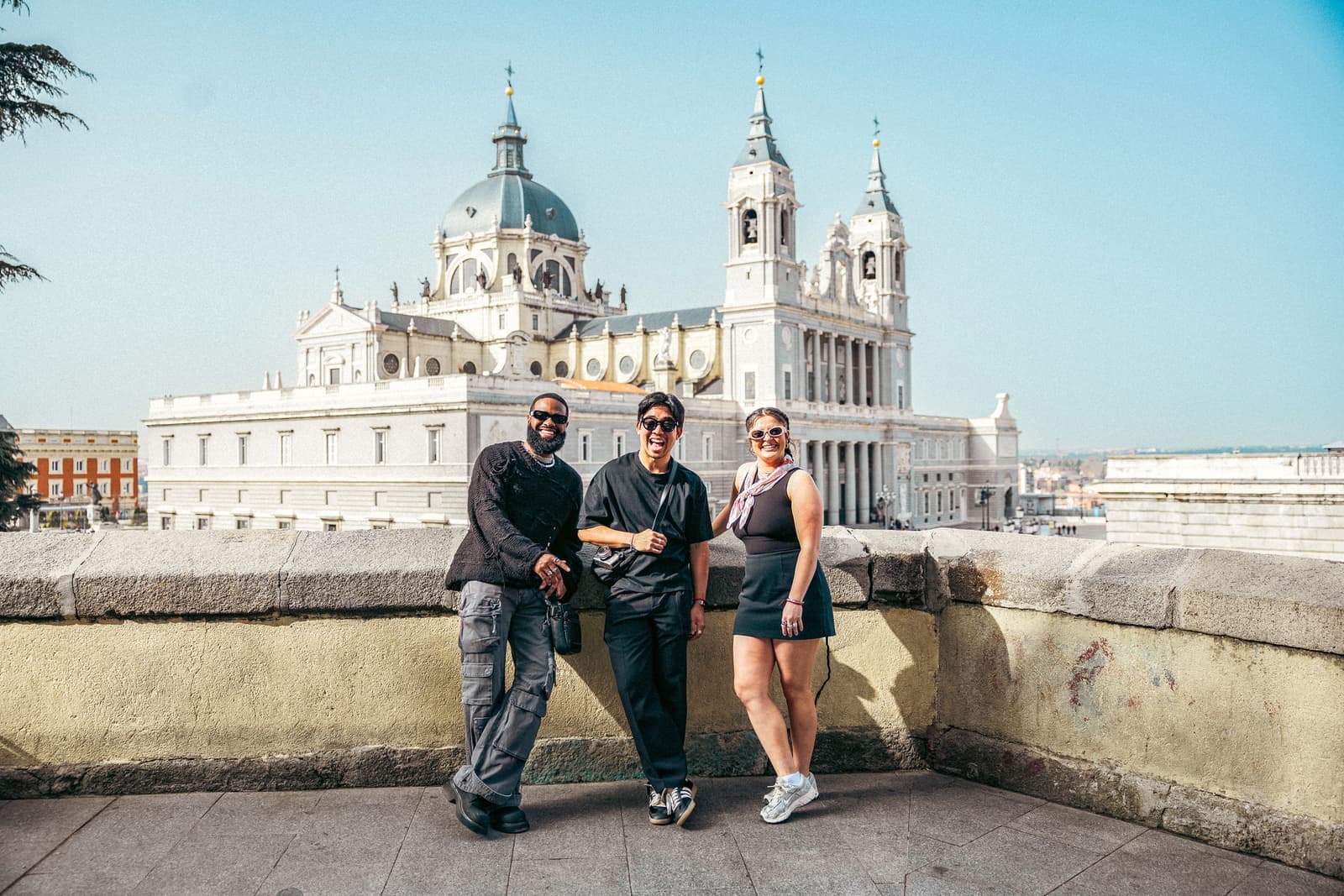 Travellers stood at viewpoint overlooking the Almudena Cathedral, Madrid, Spain