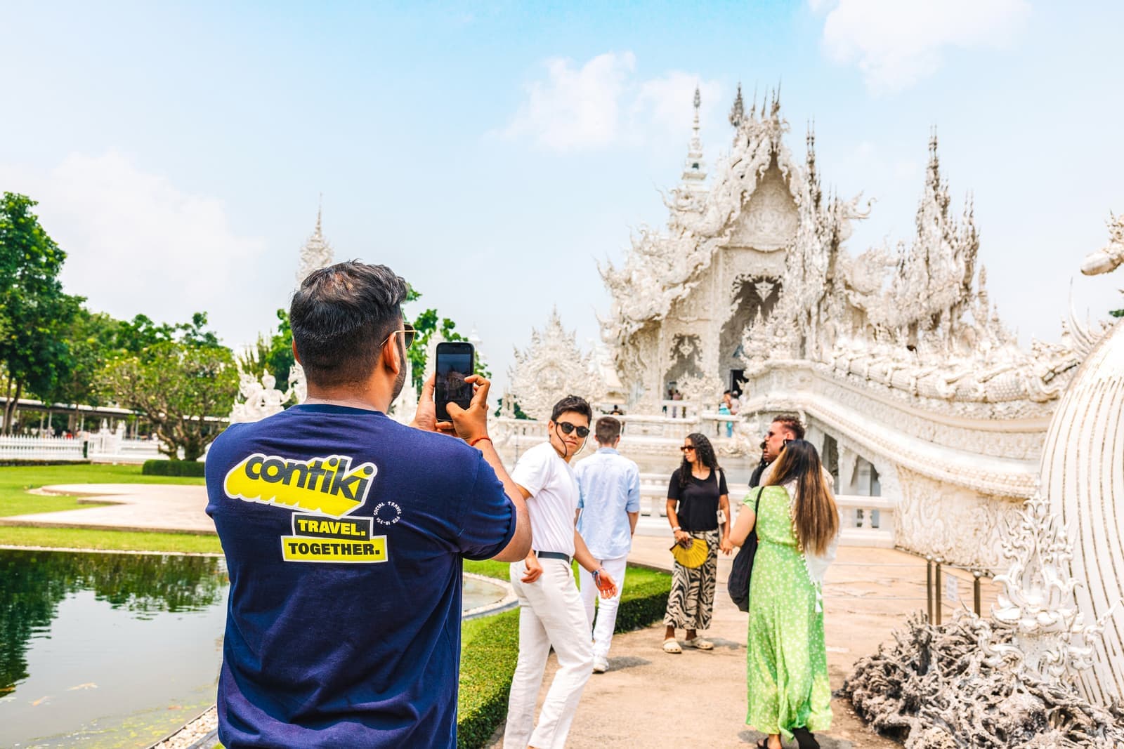 Contiki trip manager taking a photo of travellers at Chiang Rai, Thailand