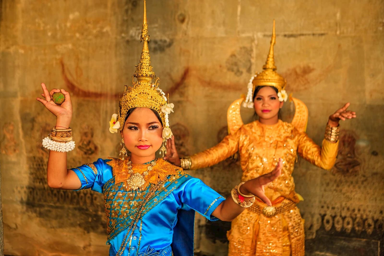 Apsara dancers in traditional Cambodian attire performing classical dance
