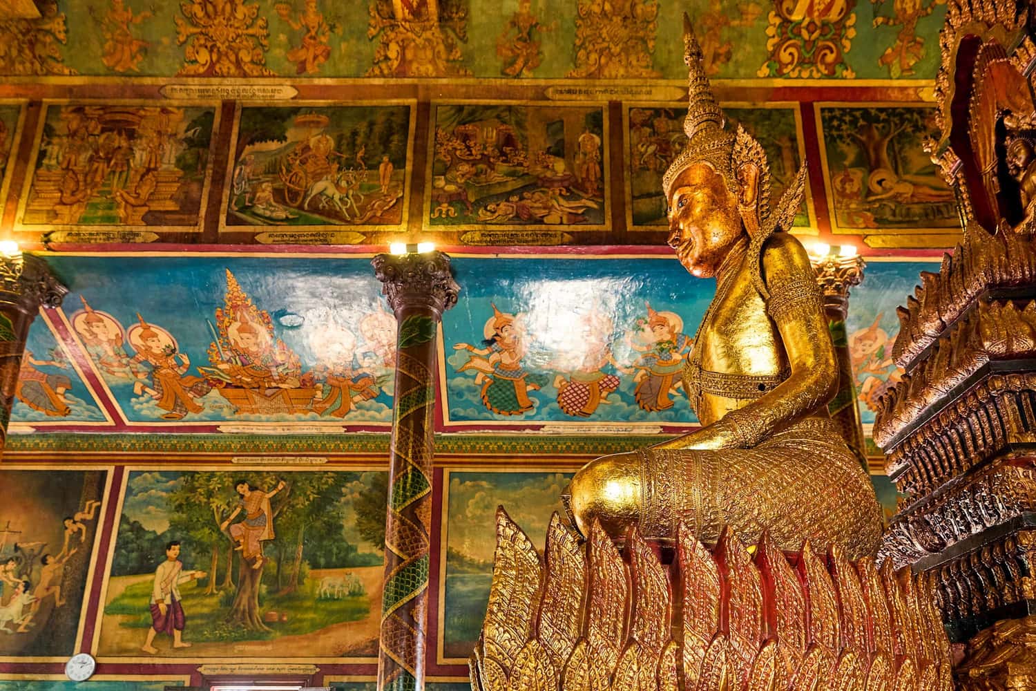 Wat Phnom Temple interior with golden statue in Phnom Penh, Cambodia