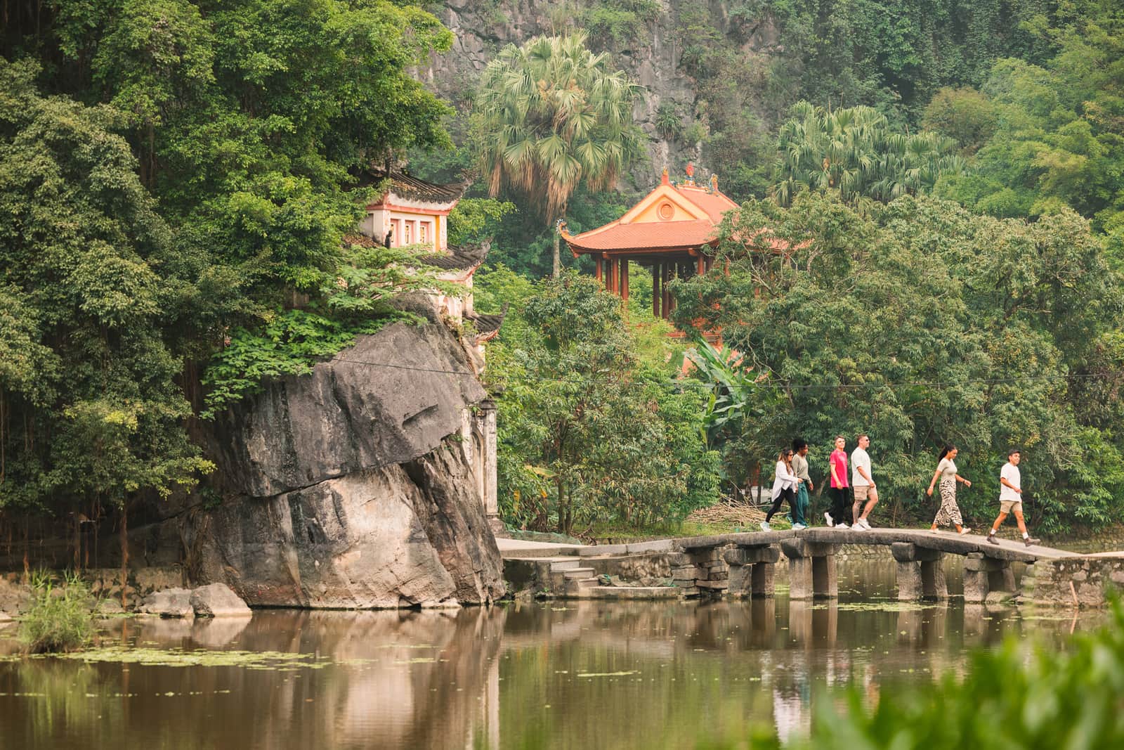 Traveller Wearing a Nón Lá and Looking Out Over River and Valley, Ninh Binh, Vietnam
