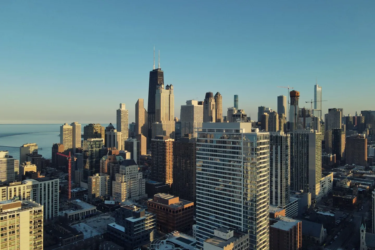 Aerial shot of Chicago skyline featuring high-rise buildings under a clear blue sky.