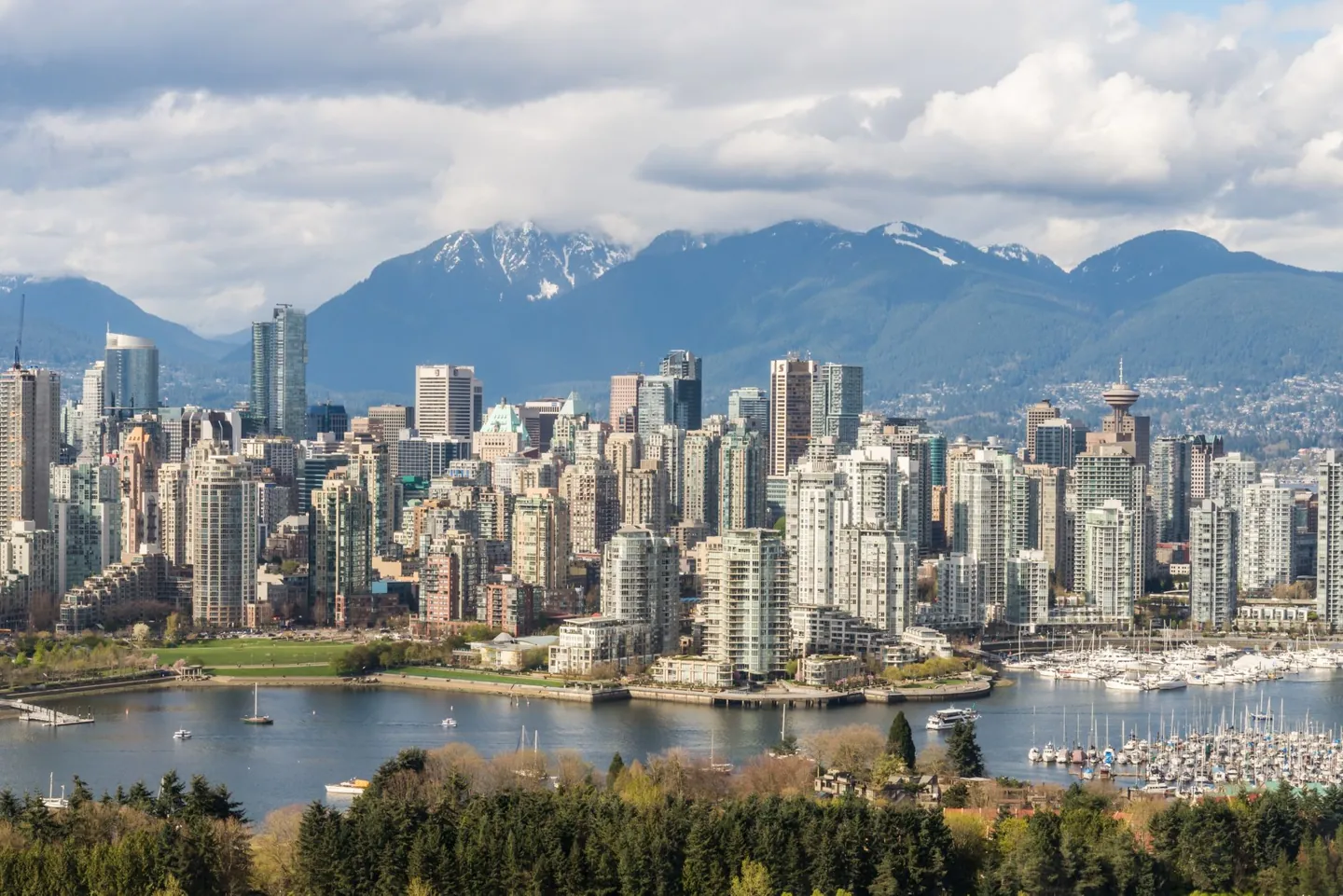 Vancouver skyline and harbour below snow-capped mountains, a main departure port for Alaska cruises